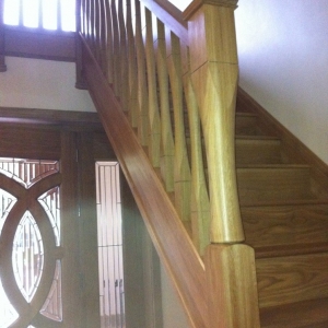 Solid oak, with slender spindles and newels